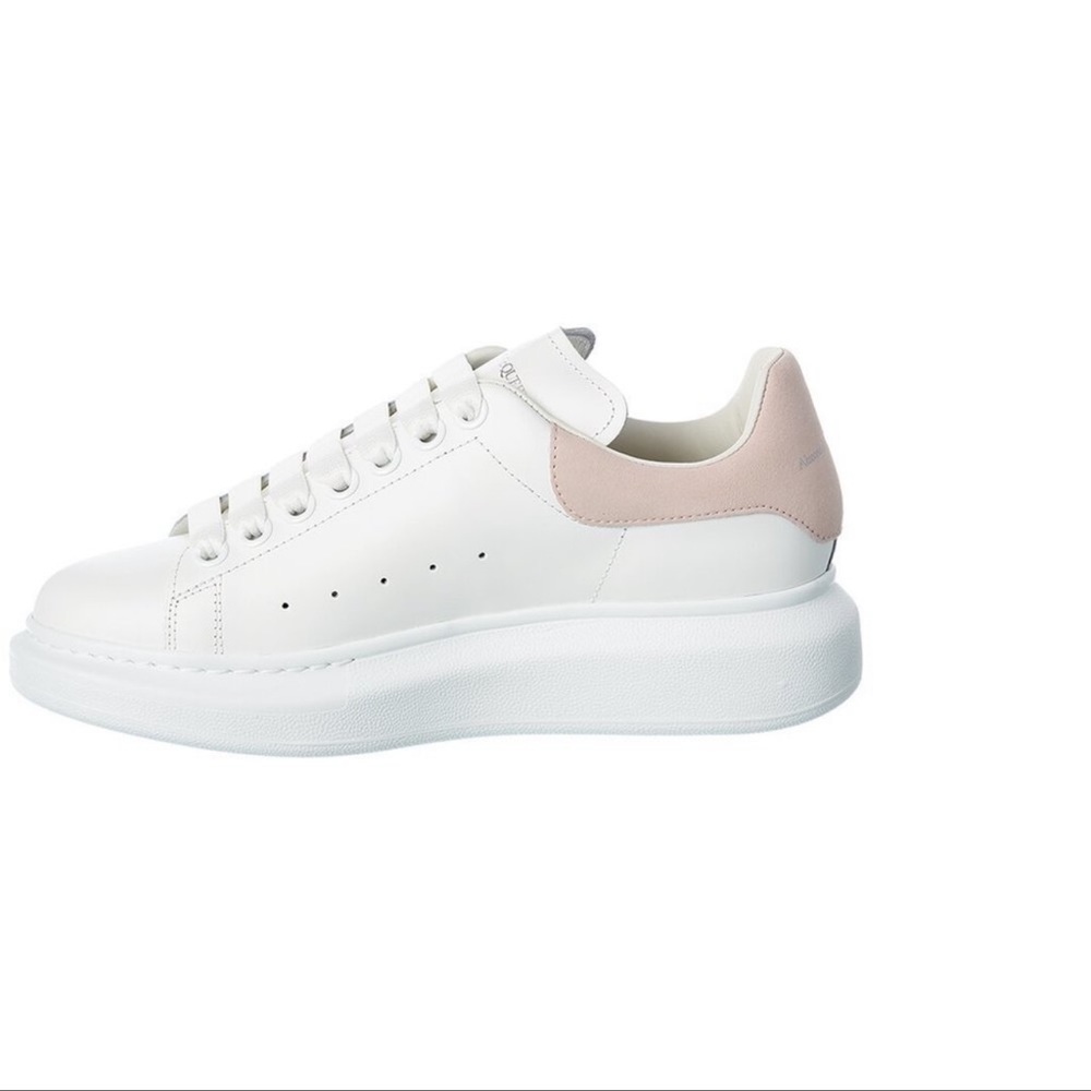 leather sneakers with perforations and an embossed logo detail. Made in Italy